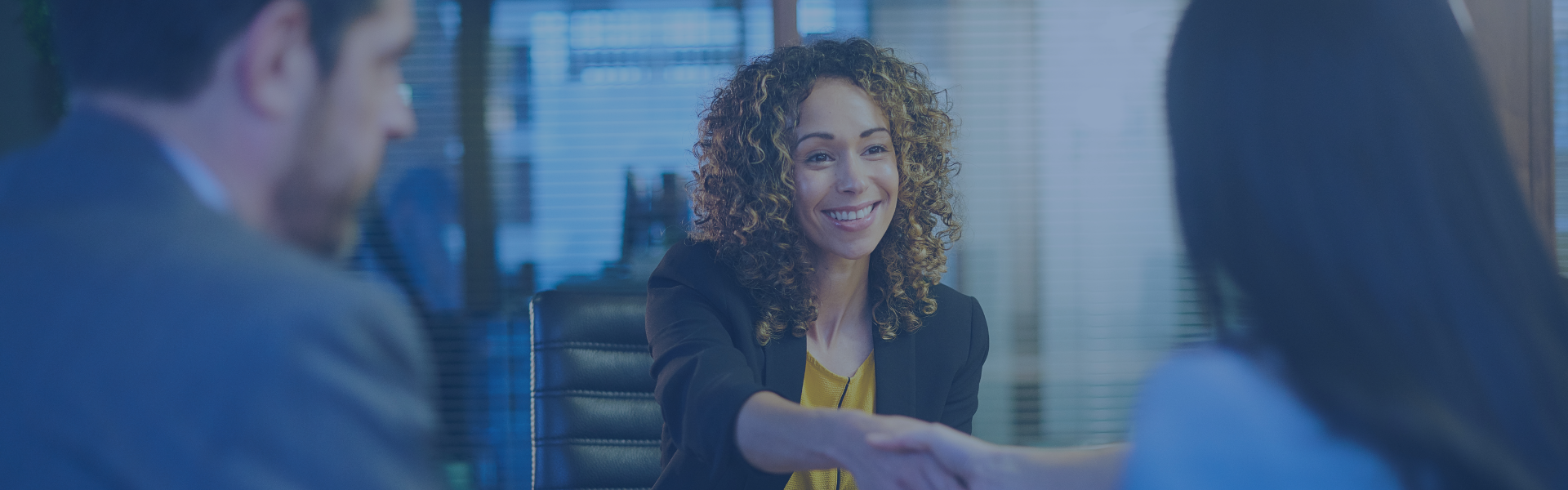 A woman shaking hands with employer